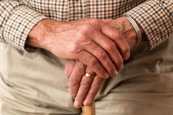 senior hands holding cane
